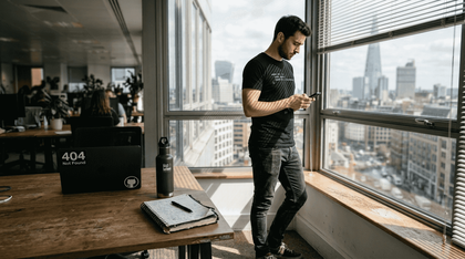 Developer in coding t-shirt near office window