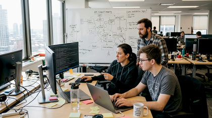 Developers collaborating in cluttered office
