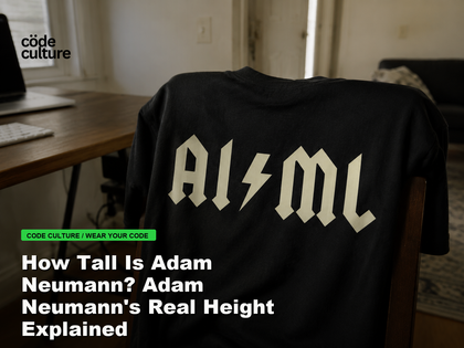 Code Culture blog banner for How Tall Is Adam Neumann? Adam Neumann's Real Height Explained, featuring a aiml 100416 developer t-shirt.