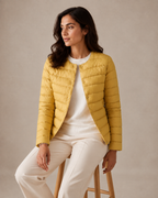 Women's Lightweight Down-Filled Quilted Jacket for Layering in Ginger Yellow, 03 seated or leaning, worn by model