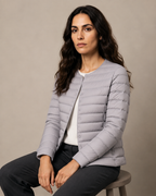 Women's Lightweight Down-Filled Quilted Jacket for Layering in Silver, 03 seated or leaning, worn by model