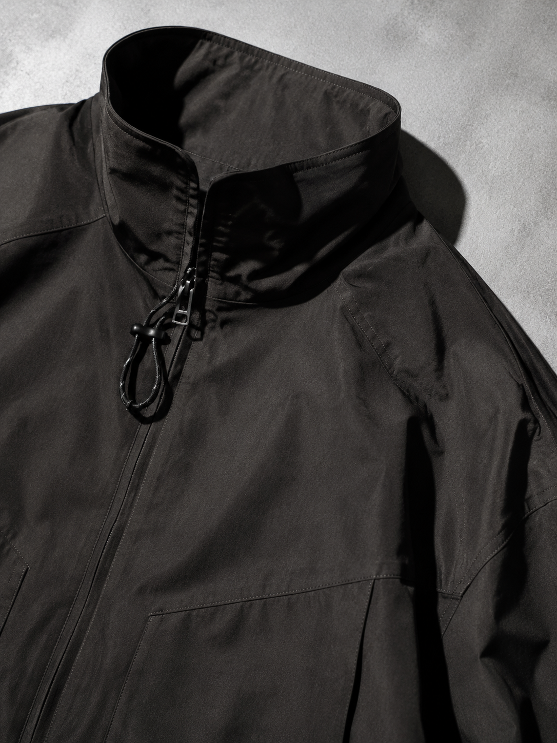 Code Culture catalog | outdoor-shell-jacket-commuting-functional-workwear | color-a003-black | macro flat lay