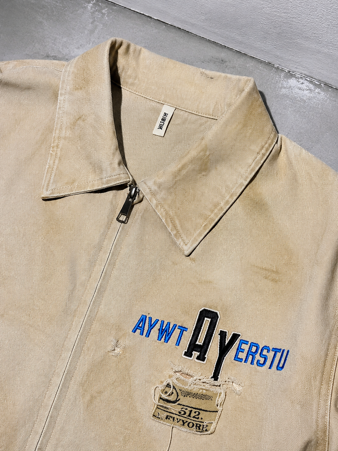 Code Culture catalog | embroidered-lapel-workwear-jacket-for-men | color-khaki | macro flat lay