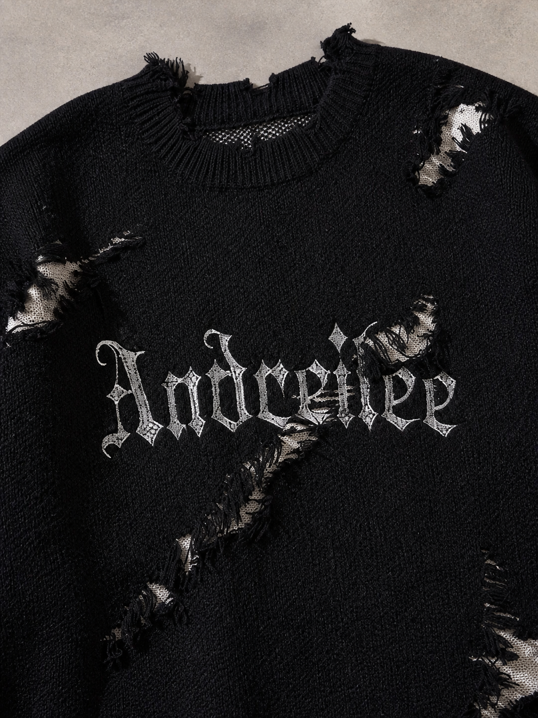 Code Culture catalog | new-personality-street-jacquard-ripped-frayed-vintage-loose-sweater | black | macro flat lay