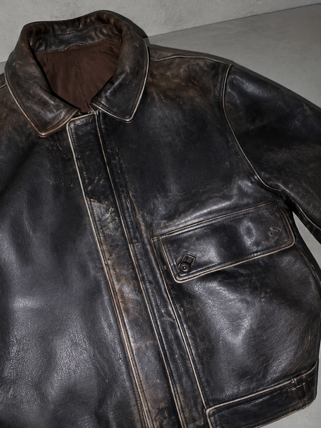 Code Culture catalog | jacket-coat-retro-washed-brushed-brown-distressed | color-brown-distressed-leather-coat | macro flat lay