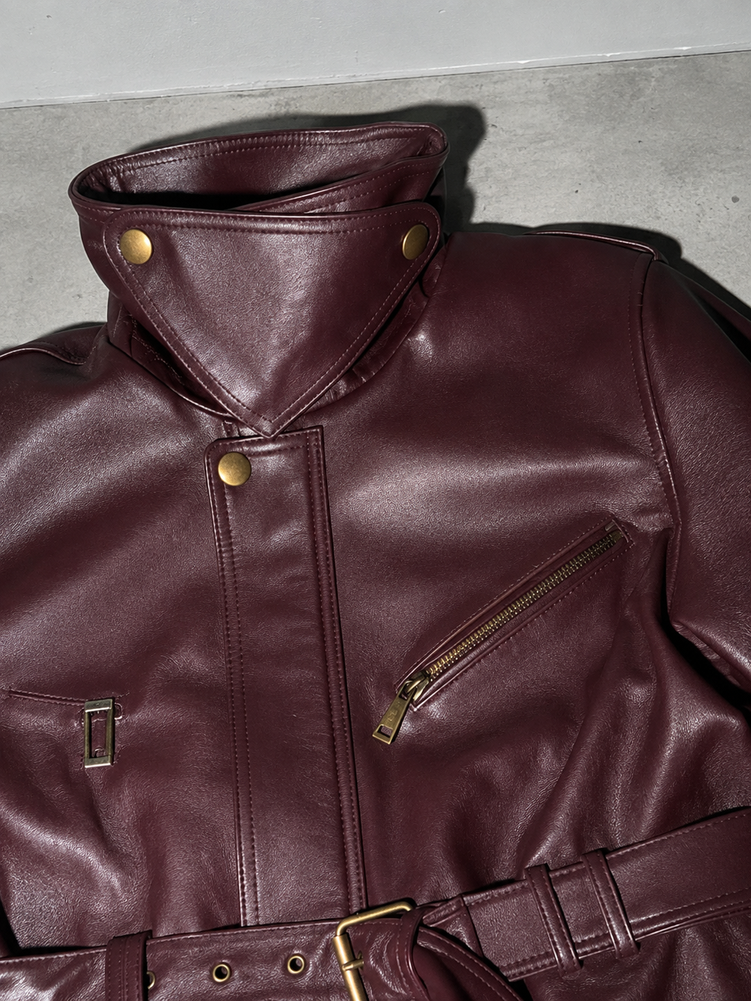 Code Culture catalog | womens-short-leather-jacket-with-lacing | color-wine-red | macro flat lay