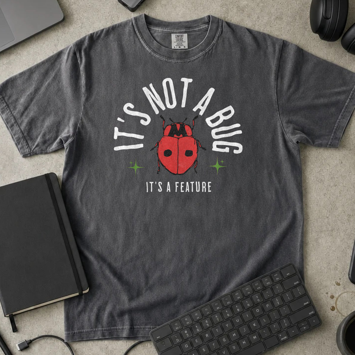 It's Not a Bug It's a Feature Shirt in Pepper, Comfort Colors 1717 tee flat lay