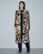 Women's Black Printed Velvet Long Coat, frontal relaxed stand, worn by model
