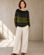 Women's Fashionable Pullover Sweater Top in Green, hands in pockets, worn by model