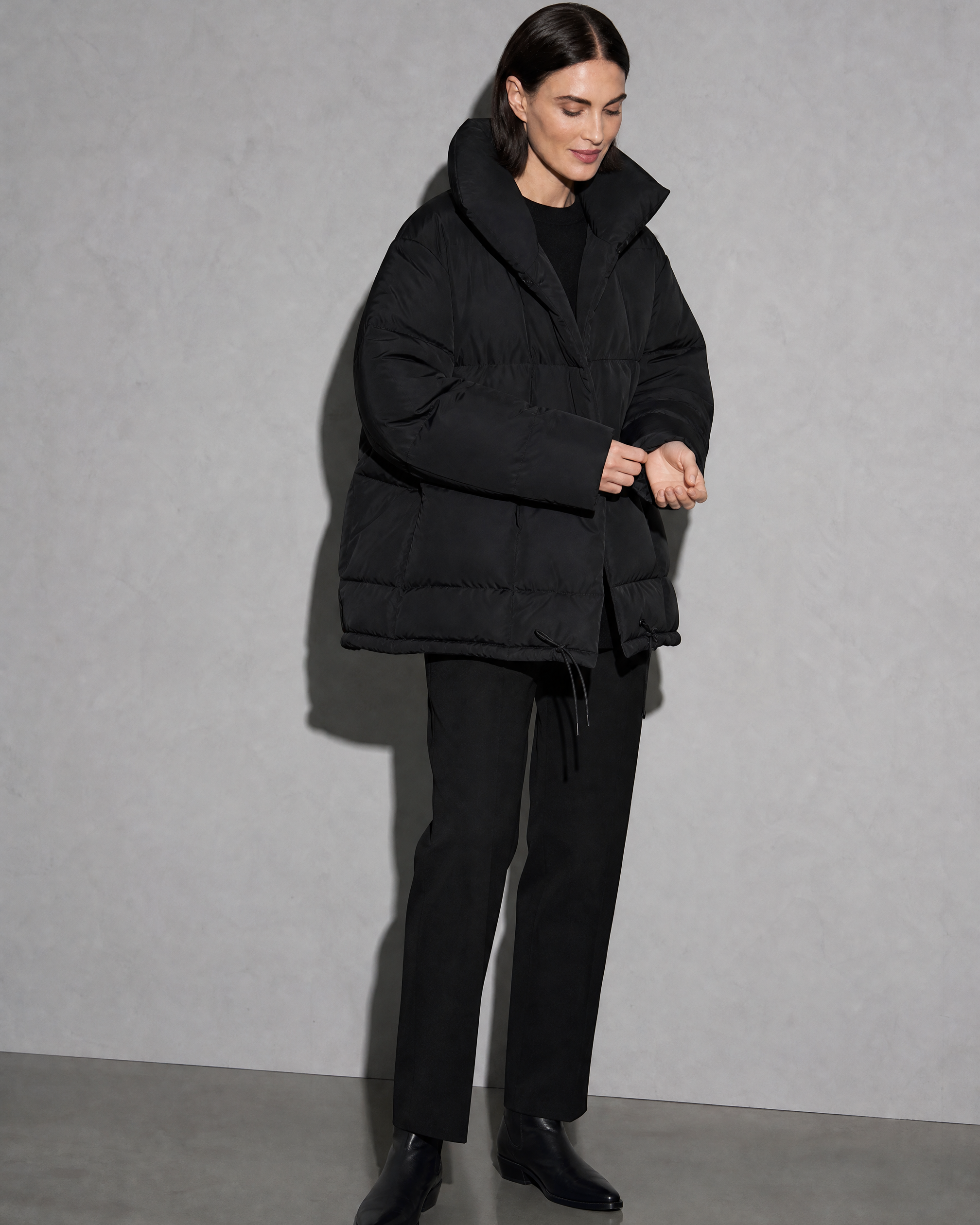 Women's Fashion Loose Thickening Keep Warm Coat, adjusting the sleeve, worn by model