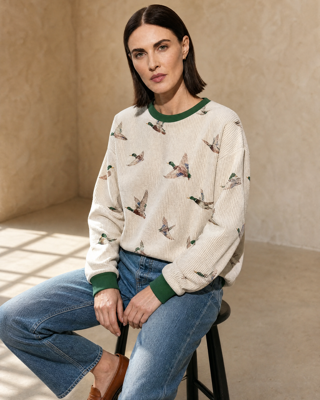 Womens Relaxed-fit Pullover Sweatshirt With An Animal Print in Beige, stool, forearms on thighs, worn by model