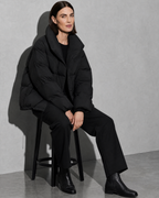 Women's Fashion Loose Thickening Keep Warm Coat, stool, forearms on thighs, worn by model