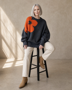 Women's Fashionable Pullover Sweater Top in Charcoal, stool, leaning back, worn by model