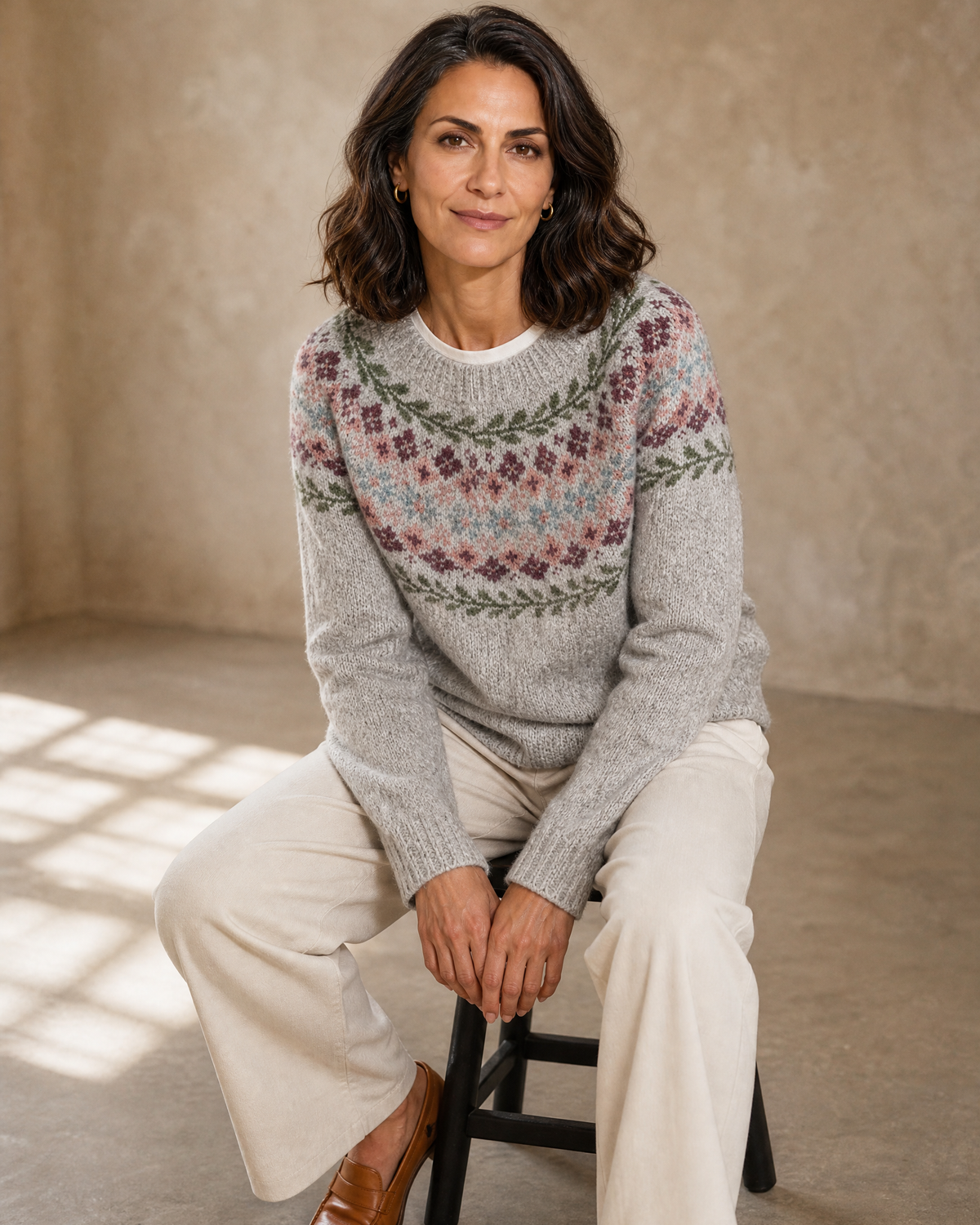 Women's Fashionable Pullover Sweater Top in Grey, perched on stool edge, worn by model