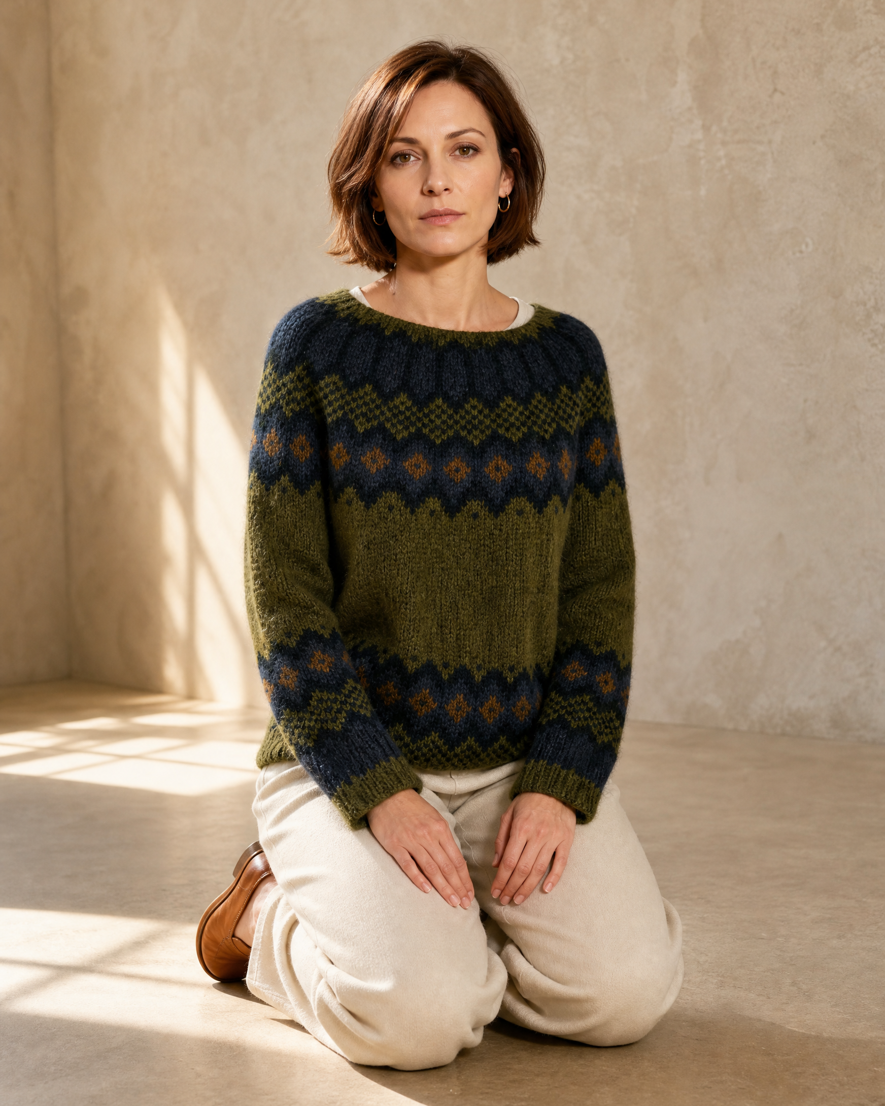 Women's Fashionable Pullover Sweater Top in Green, kneeling upright, worn by model