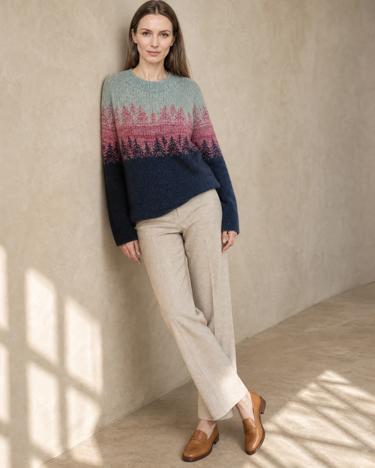 Women's Fashionable Pullover Sweater Top in Pink, shoulder blade to wall, ankles crossed, worn by model