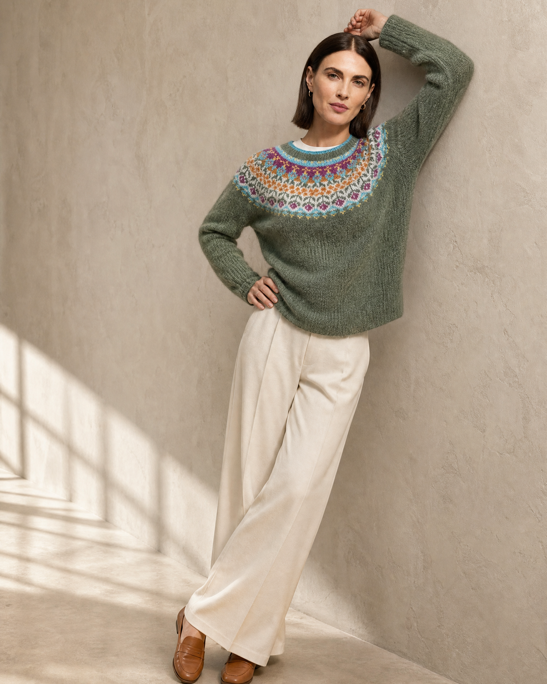 Women's Fashionable Pullover Sweater Top in Light Green, wall lean, arm overhead, worn by model