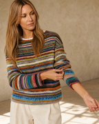 Women's Fashionable Pullover Sweater Top in Orange, sleeve held away, worn by model