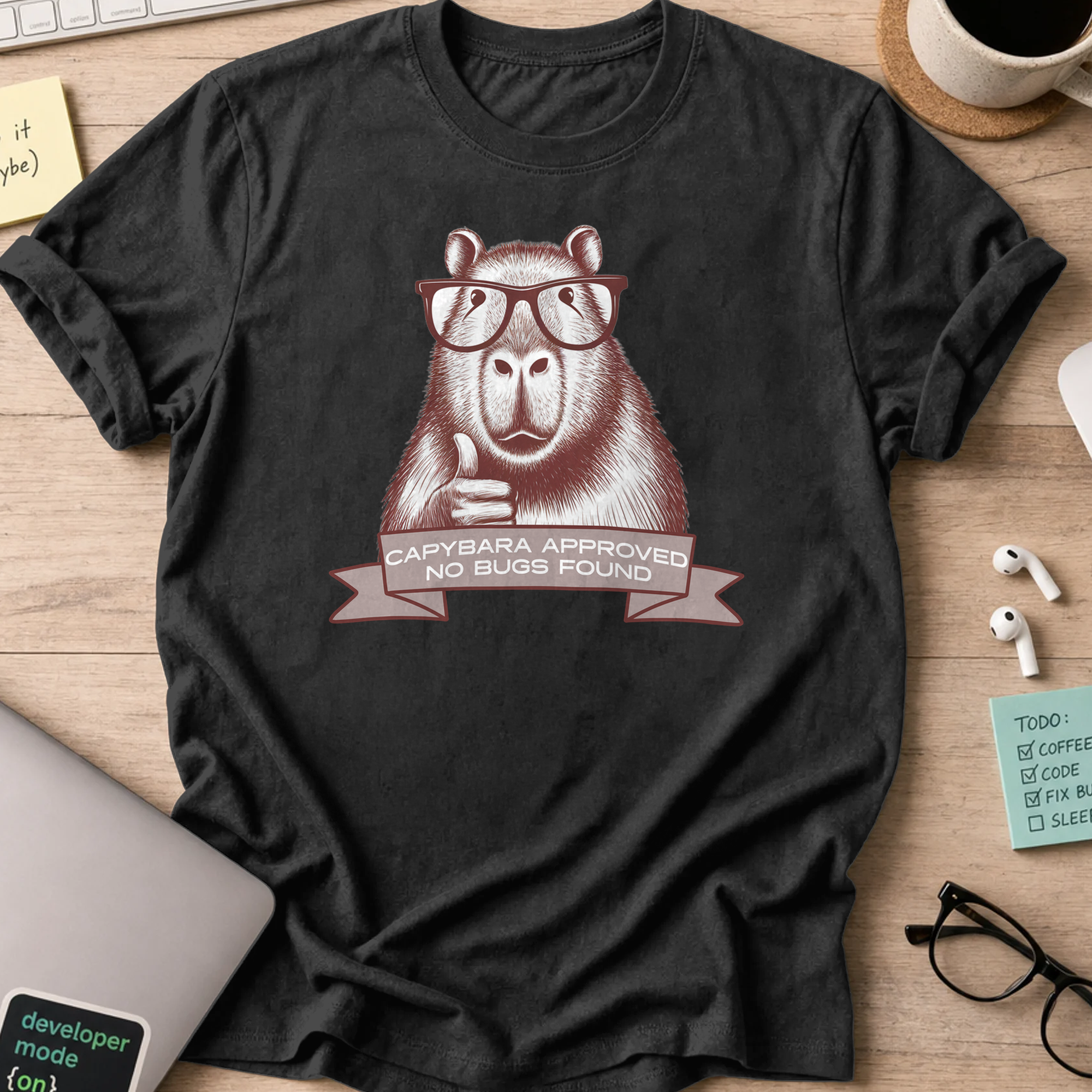 Black programmer shirt printed with "Capybara approved", a funny developer t-shirt and coding gift for software engineers and coders.