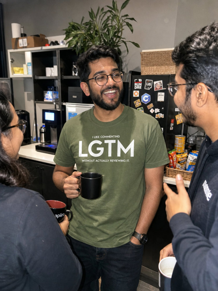 Developer in the green LGTM tee chatting by the office coffee machine
