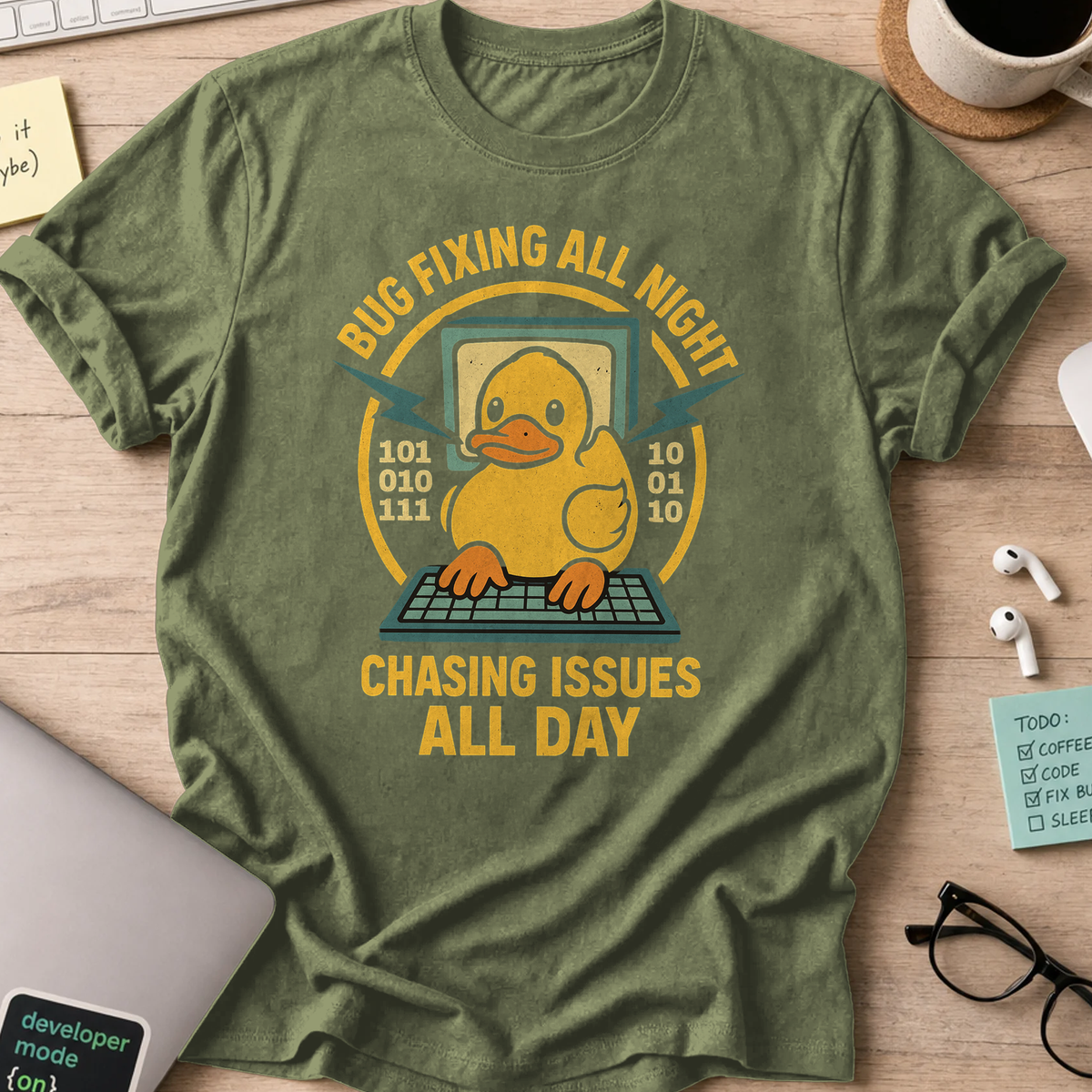 Military Green programmer shirt printed with "chasing issues all day", a funny developer t-shirt and coding gift for software engineers and coders.