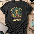 Black programmer shirt printed with "coding all night testing all day", a funny developer t-shirt and coding gift for software engineers and coders.