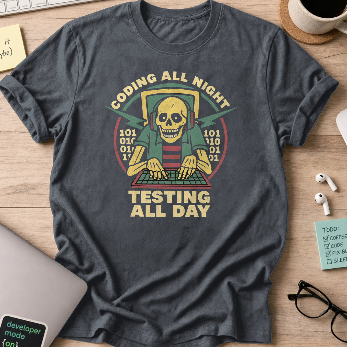 Dark Heather Grey programmer shirt printed with "coding all night testing all day", a funny developer t-shirt and coding gift for software engineers.