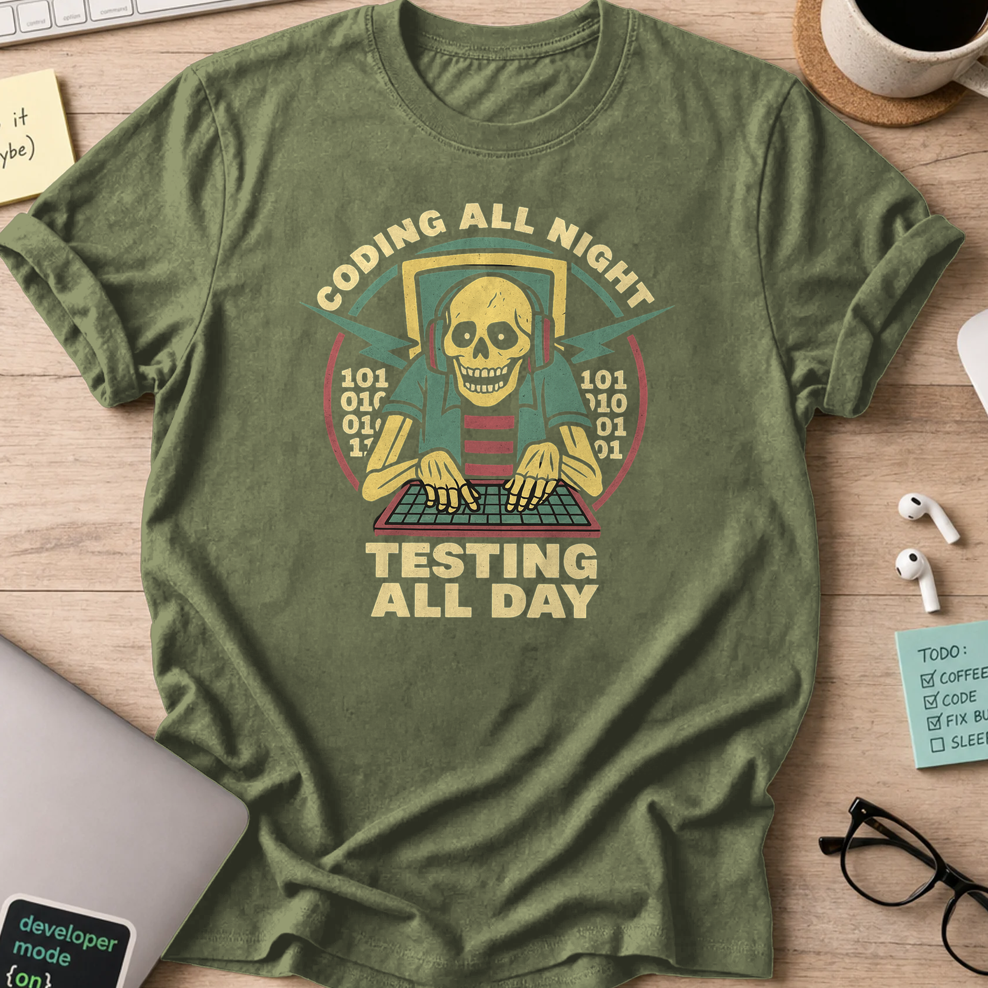 Military Green programmer shirt printed with "coding all night testing all day", a funny developer t-shirt and coding gift for software engineers.