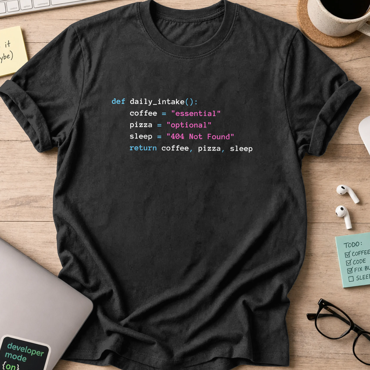 Black programmer shirt printed with "daily.intake()", a funny developer t-shirt and coding gift for software engineers and coders.