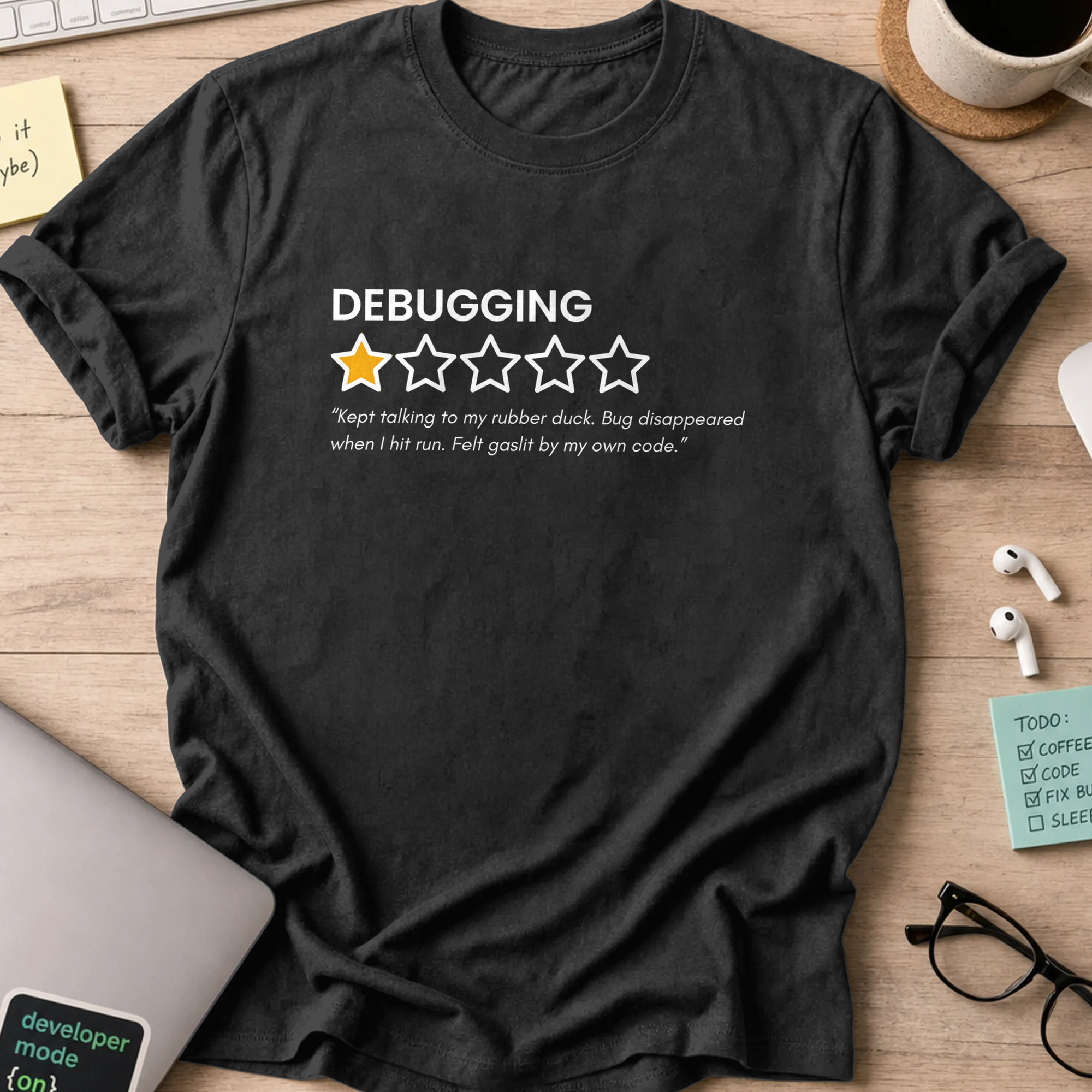 Black programmer shirt printed with "debugging review", a funny developer t-shirt and coding gift for software engineers and coders.