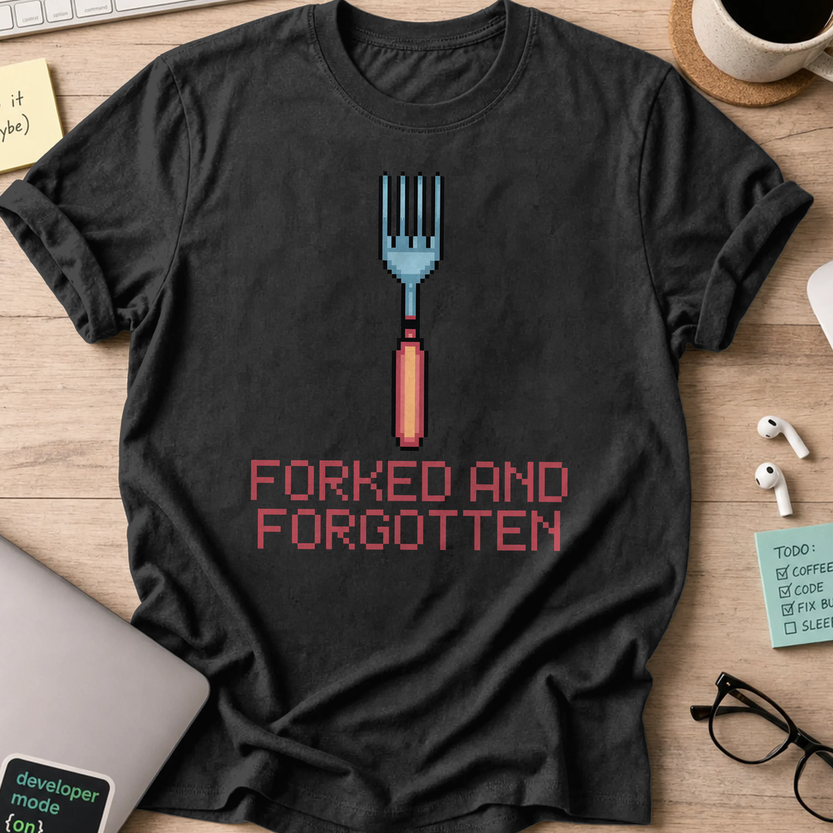 Black programmer shirt printed with "forked and forgotten", a funny developer t-shirt and coding gift for software engineers and coders.