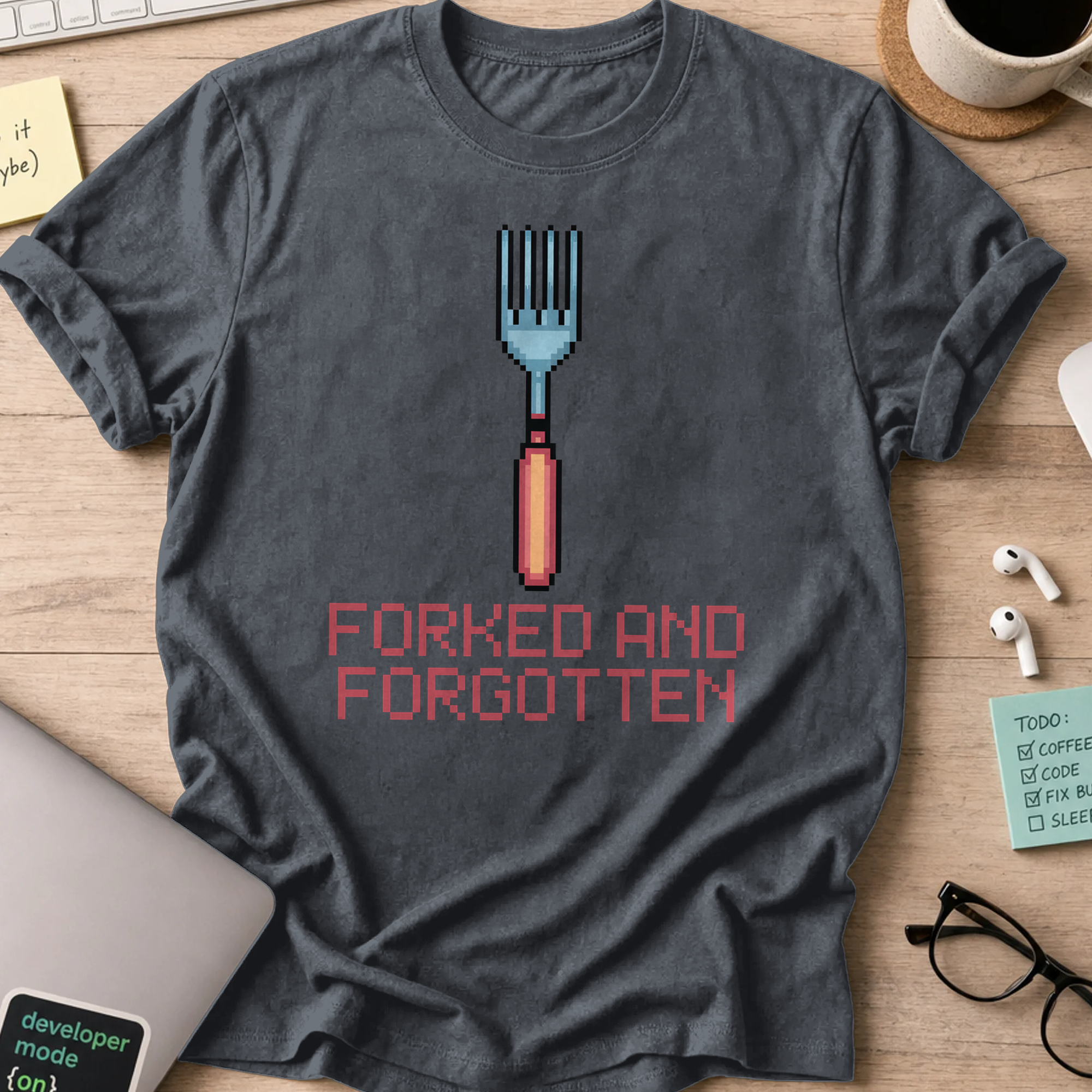 Dark Heather Grey programmer shirt printed with "forked and forgotten", a funny developer t-shirt and coding gift for software engineers and coders.