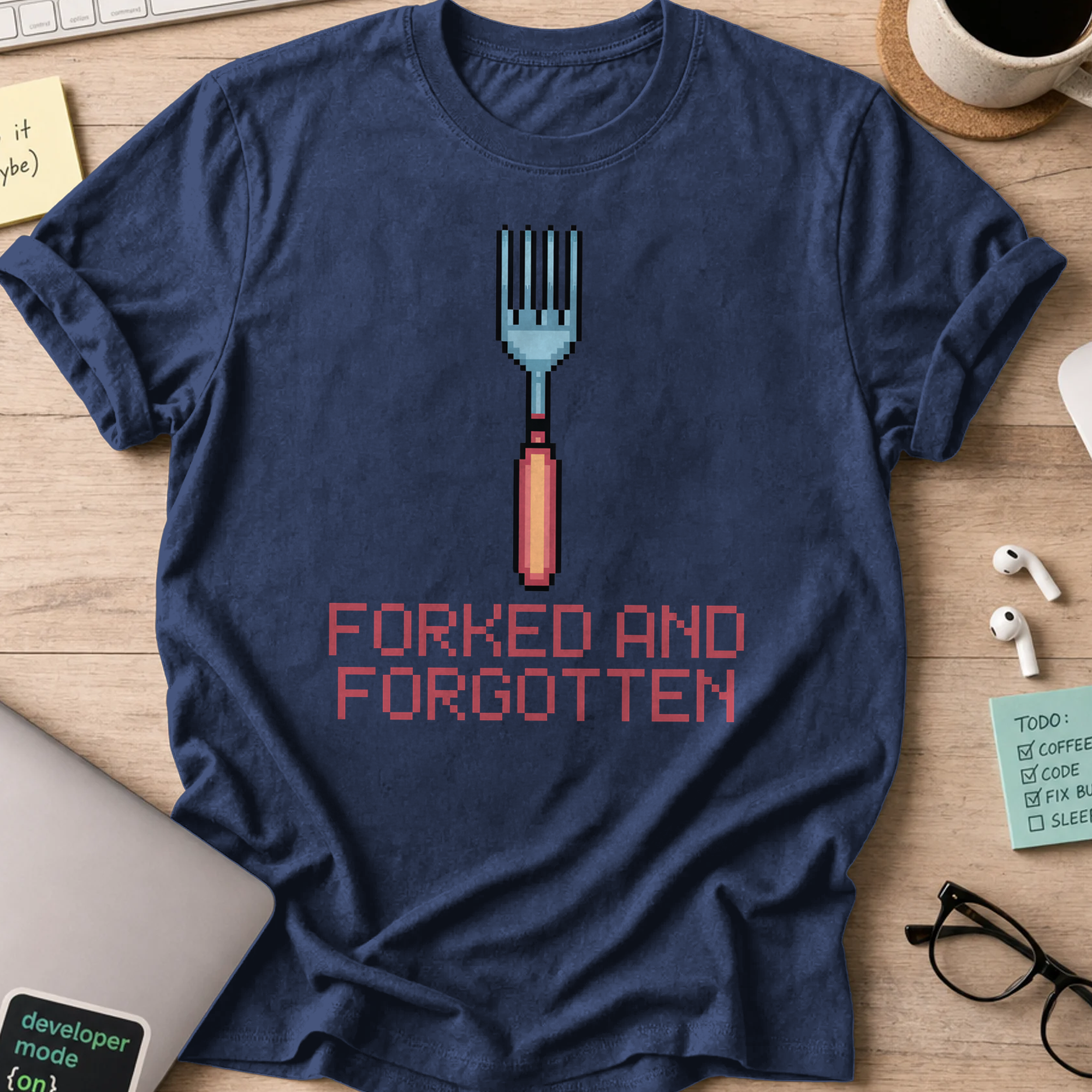 Navy programmer shirt printed with "forked and forgotten", a funny developer t-shirt and coding gift for software engineers and coders.