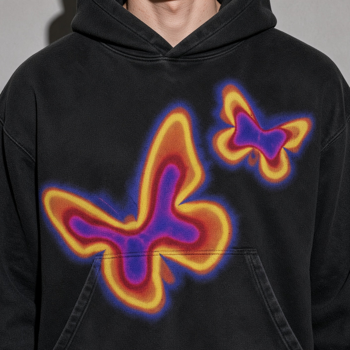 Neon butterfly hoodie graphic detail on black fleece