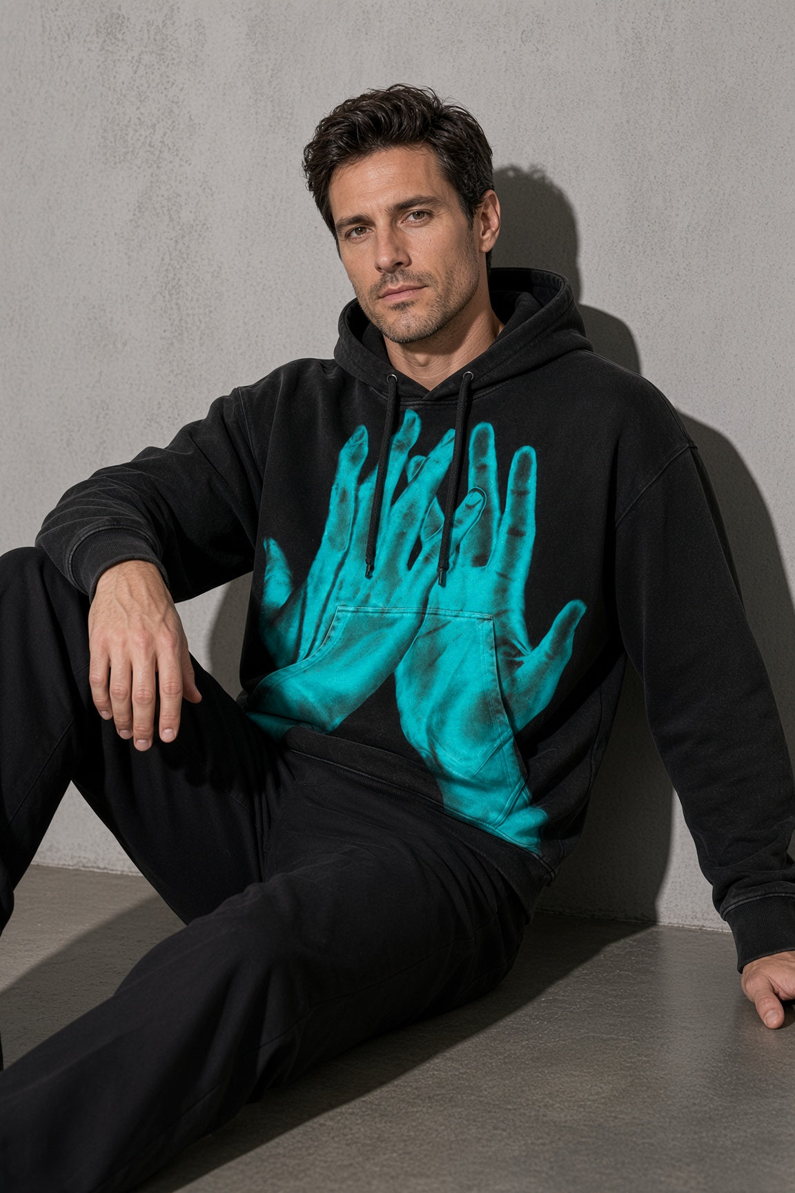 Turquoise ghost hands men's black hoodie, zoom-detail view