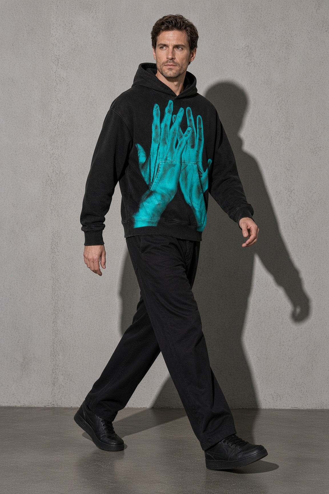 Turquoise ghost hands men's black hoodie, full-body view