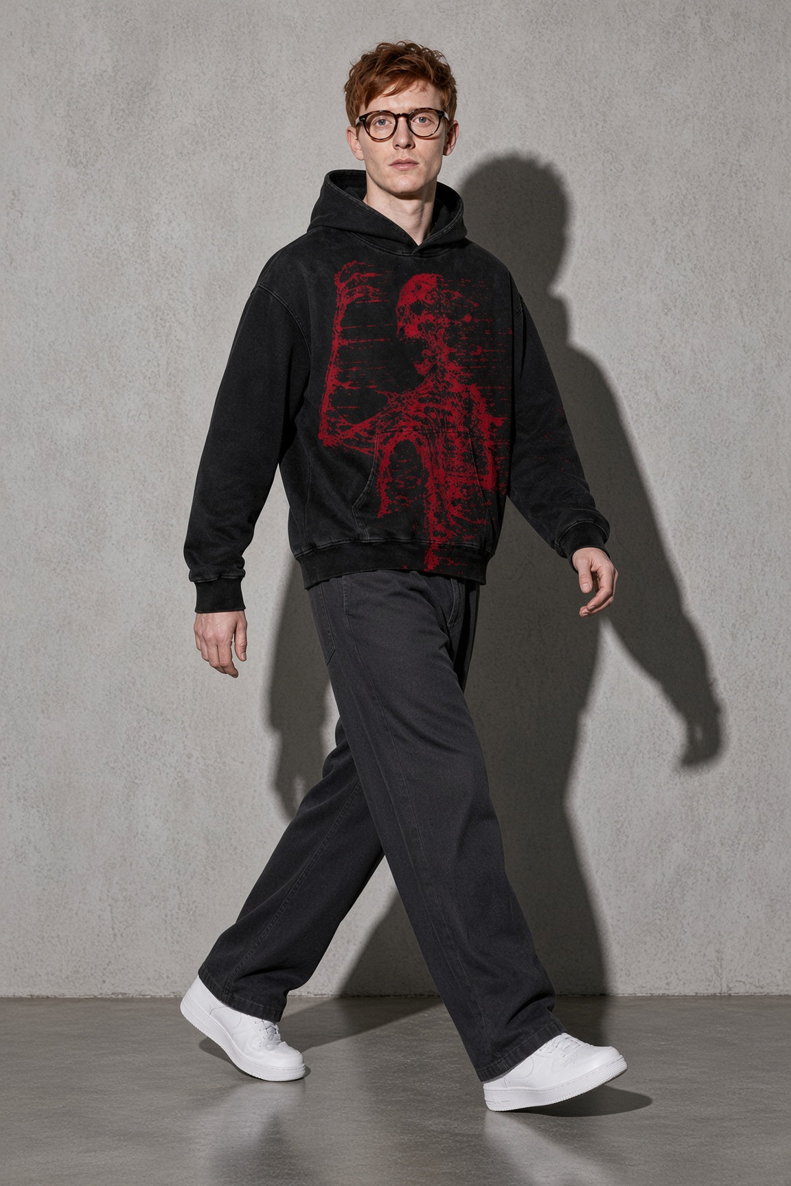 Men's black red skeleton graphic hoodie walking view