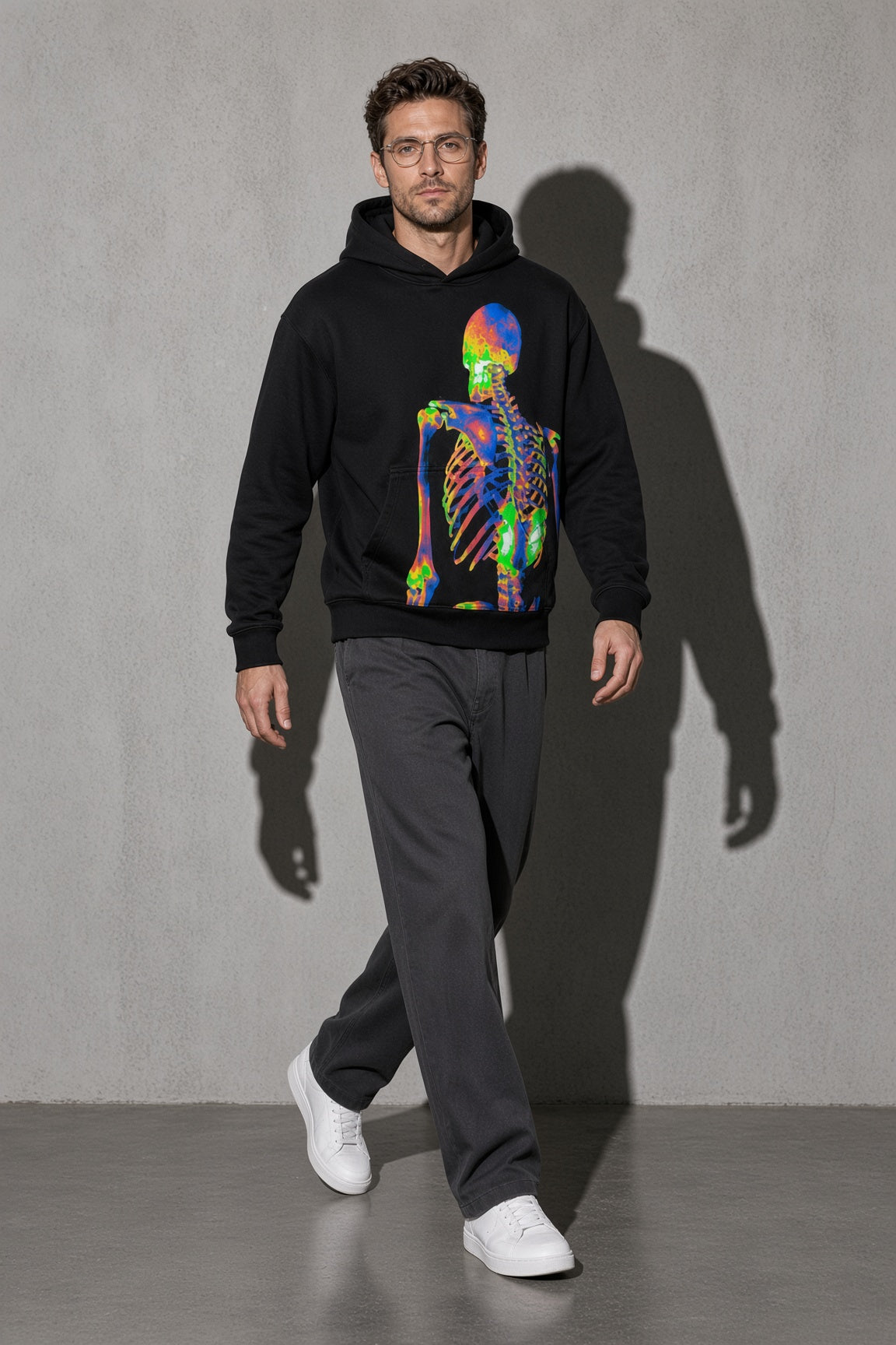 Men's black neon skeleton graphic hoodie walking view