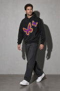 Men's black neon butterfly graphic hoodie walking view