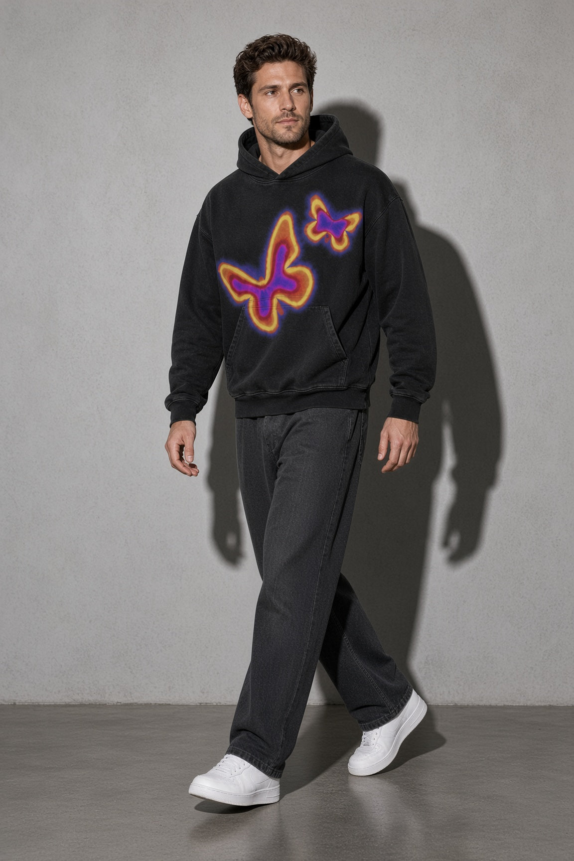 Men's black neon butterfly graphic hoodie walking view