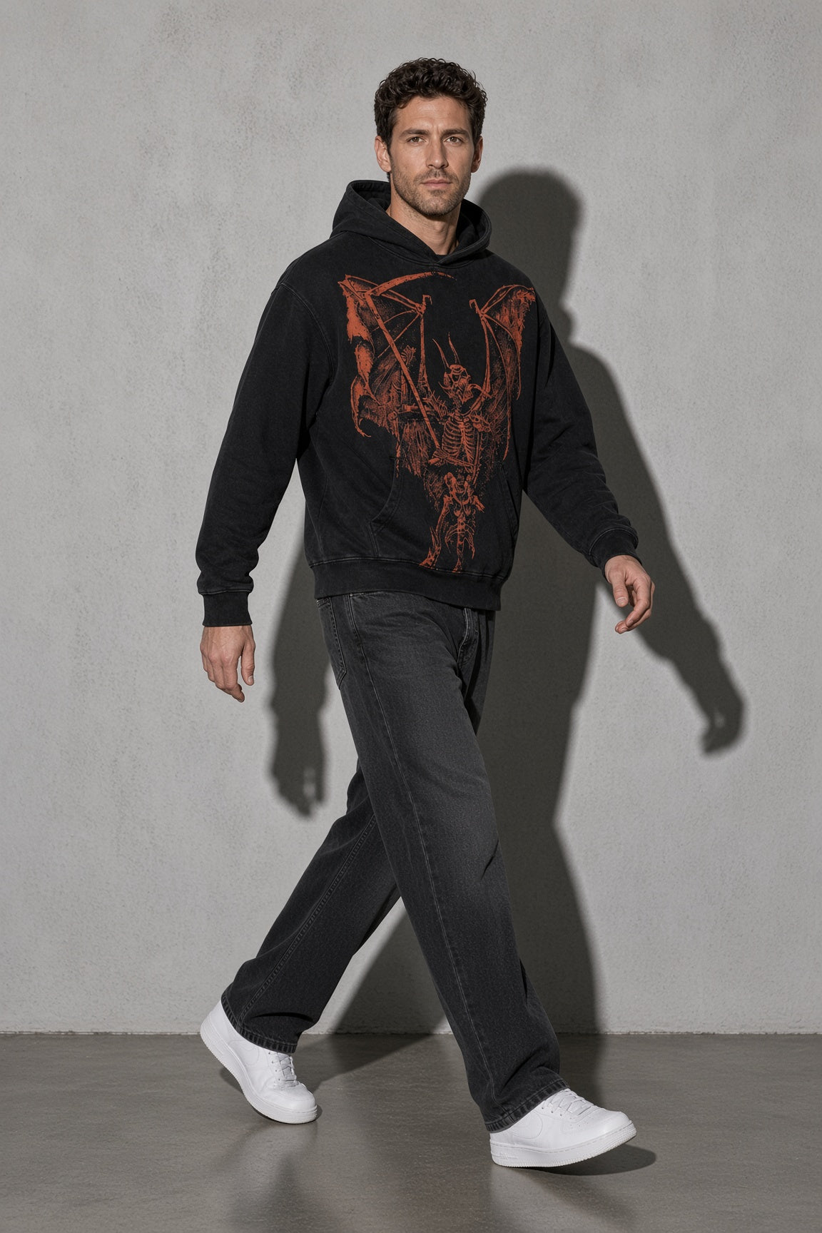 Men's black winged skeleton graphic hoodie walking view