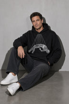 Men's black wireframe figure graphic hoodie seated view