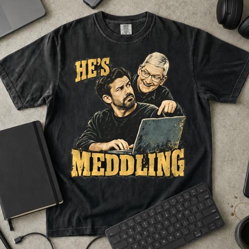 He's Meddling Shirt — Black Comfort Colors 1717 flat lay