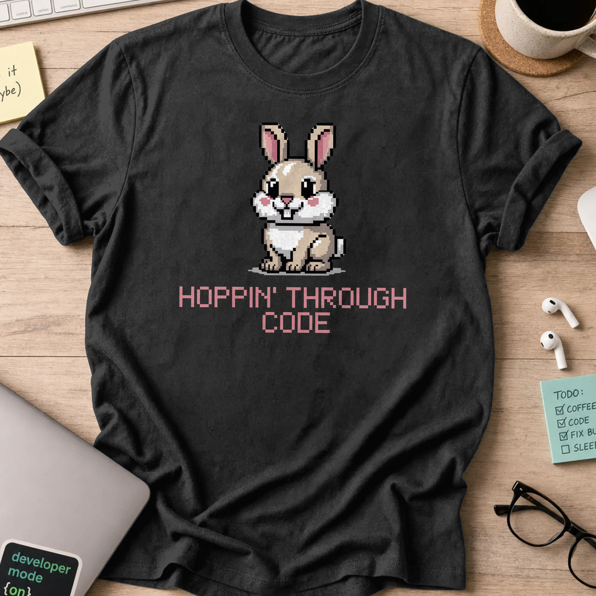 Black programmer shirt printed with "Hoppin' through code", a funny developer t-shirt and coding gift for software engineers and coders.