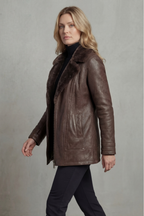 Brown shearling leather jacket with stand collar and zipped front, viewed from side