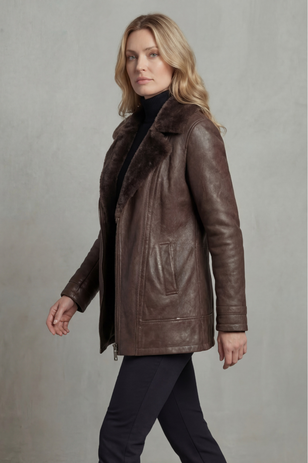 Brown shearling leather jacket with stand collar and zipped front, viewed from side