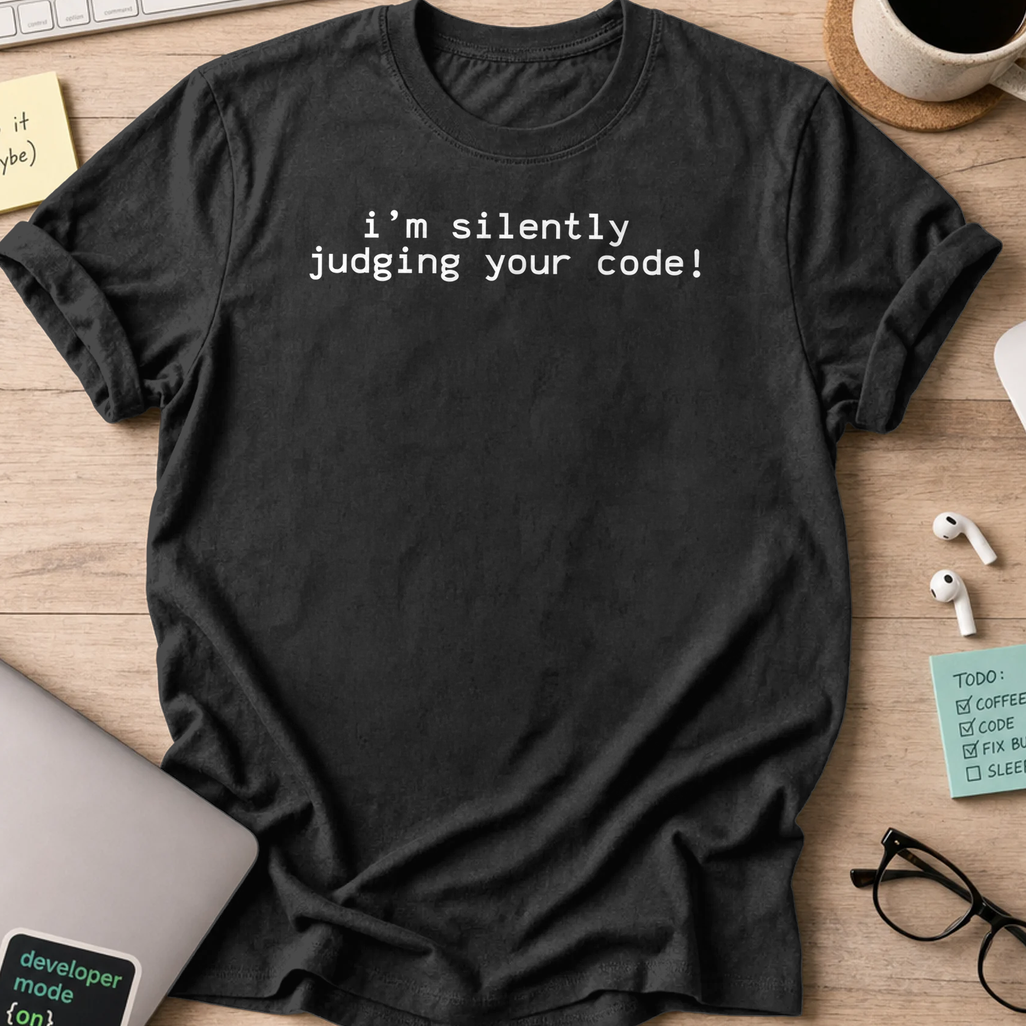 Black programmer shirt printed with "i'm silently judging your code", a funny developer t-shirt and coding gift for software engineers and coders.