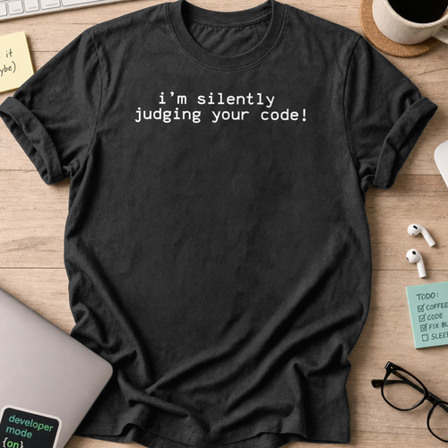 Black programmer shirt printed with "i'm silently judging your code", a funny developer t-shirt and coding gift for software engineers and coders.
