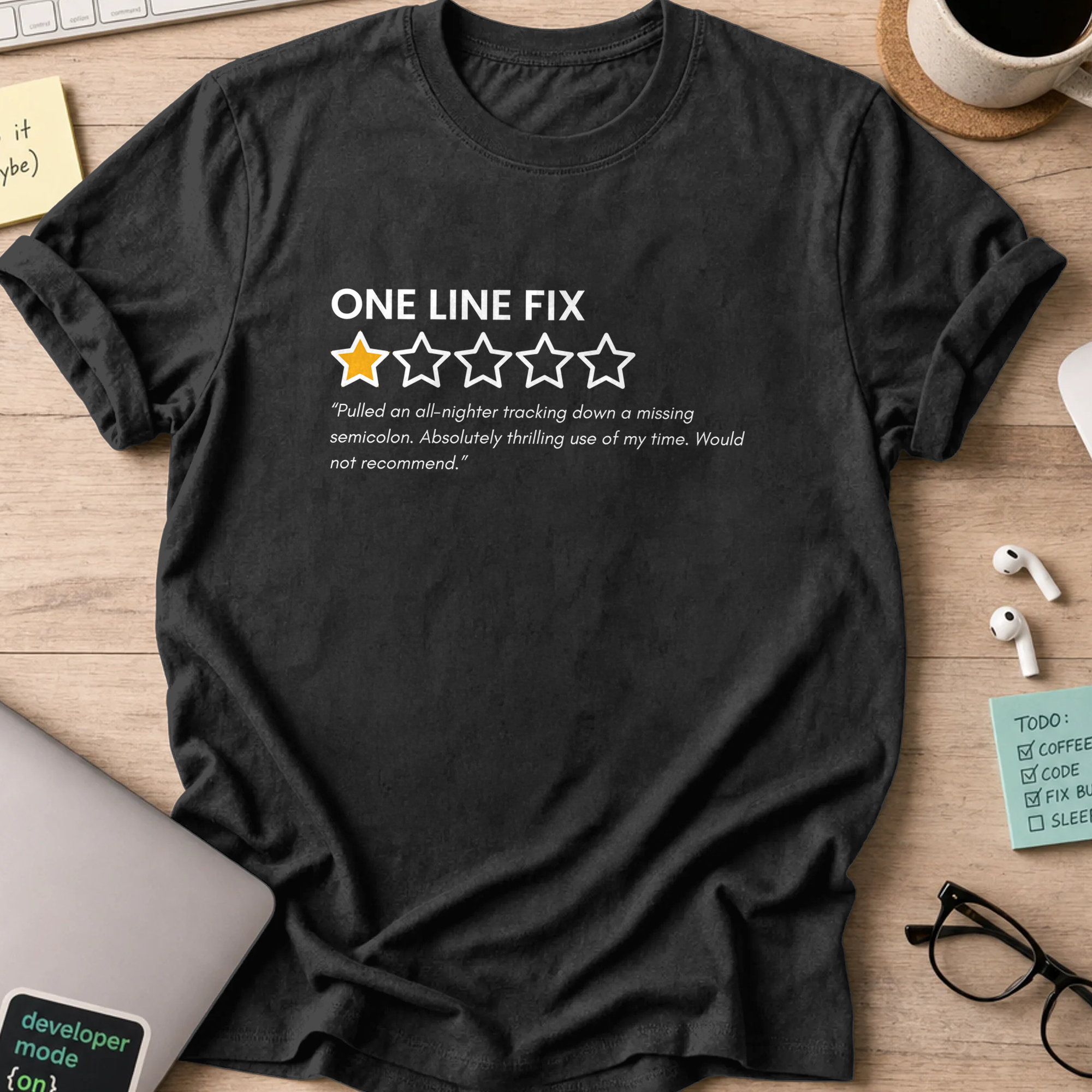Black programmer shirt printed with "one line fix review", a funny developer t-shirt and coding gift for software engineers and coders.