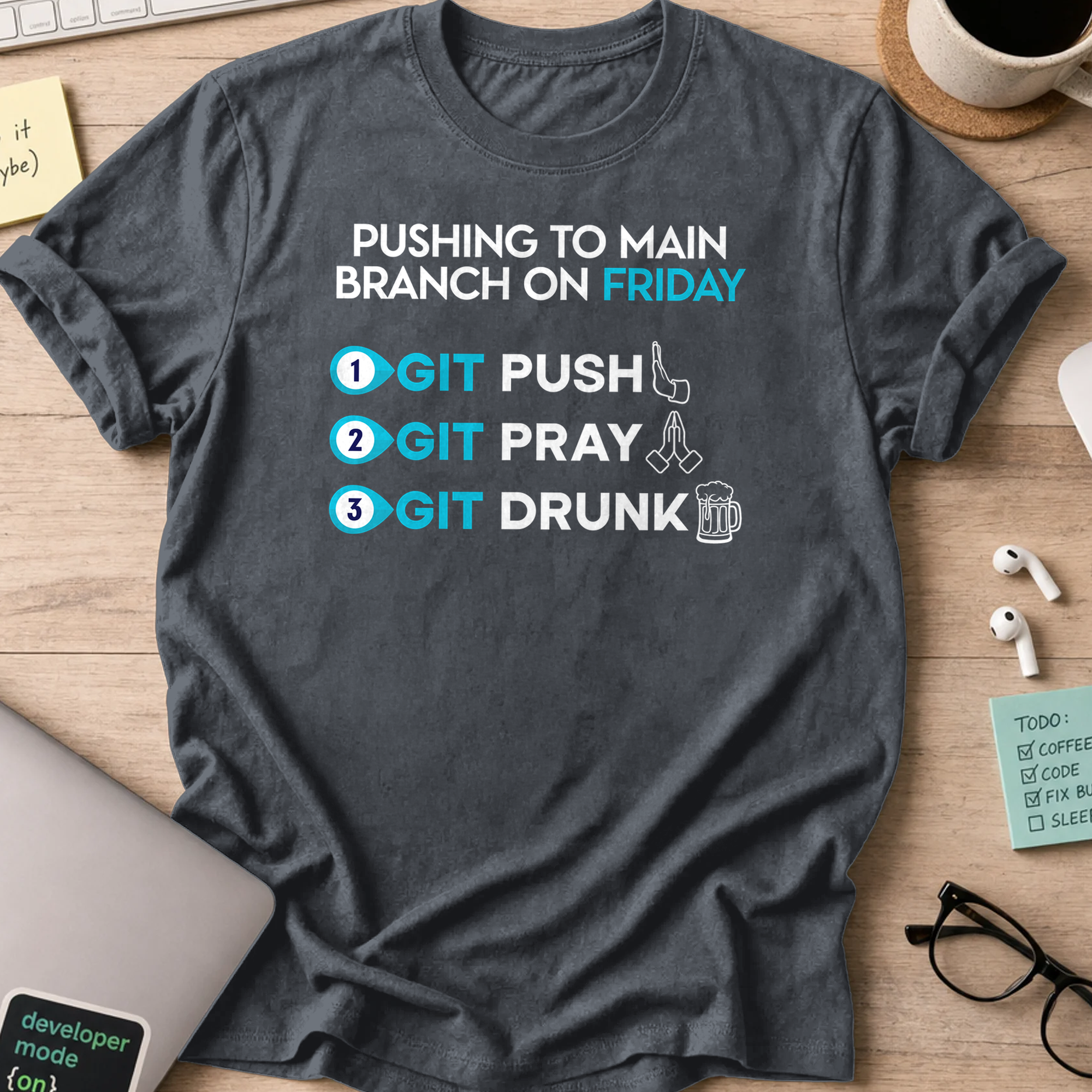 Dark Heather Grey programmer shirt printed with "pushing to main branch on friday", a funny developer t-shirt and coding gift for software engineers.